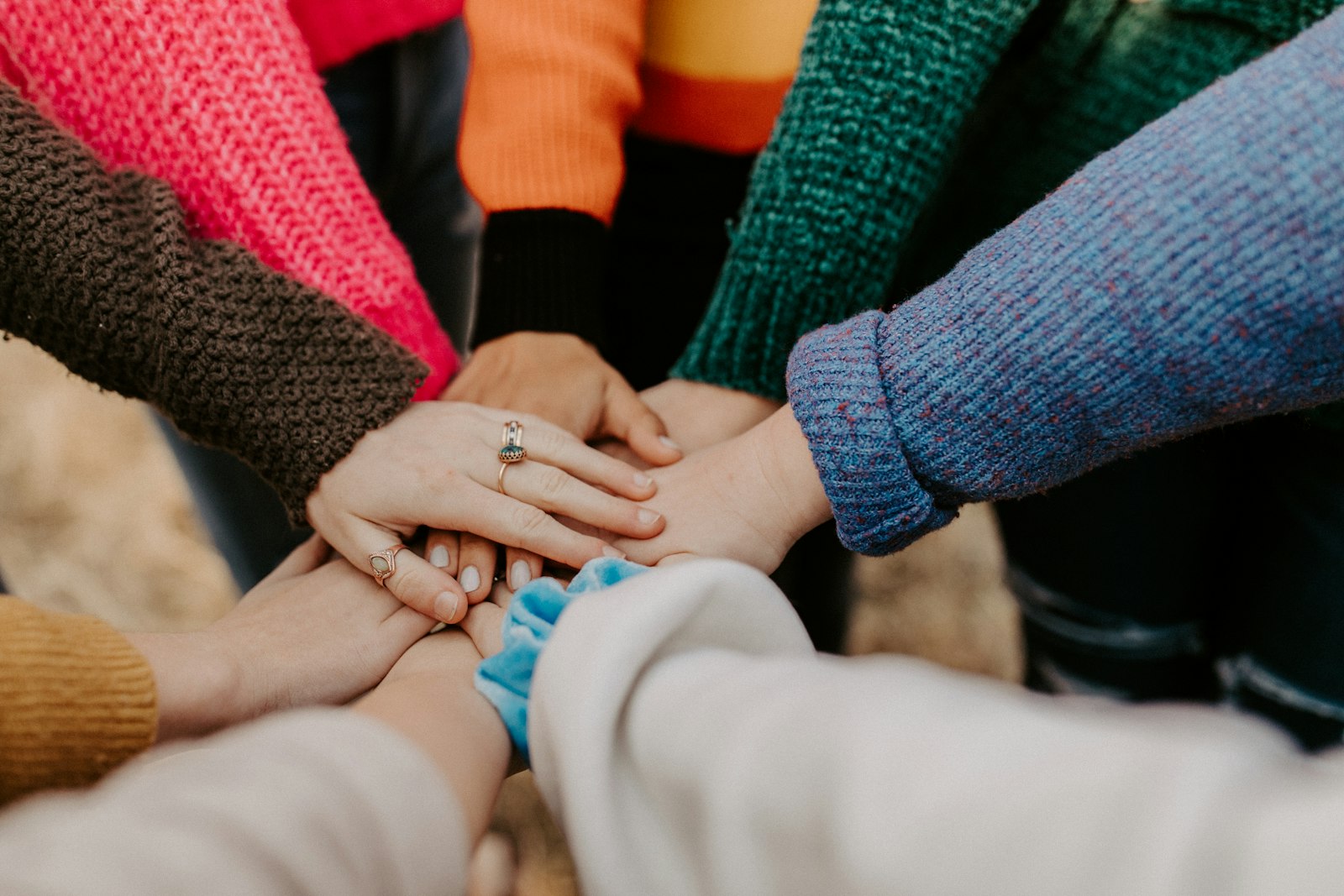 Volunteers joining hands together as a community